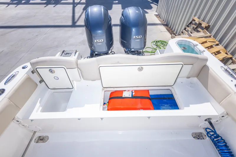 Slide: The Image of 2017 NauticStar 2602 Legacy boat with dual Yamaha 150 engines and storage compartments. - 43