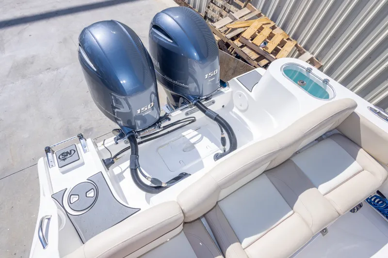 Slide: The Image of 2017 NauticStar 2602 Legacy boat with twin Yamaha 150 engines, rear seating, and livewell. - 45