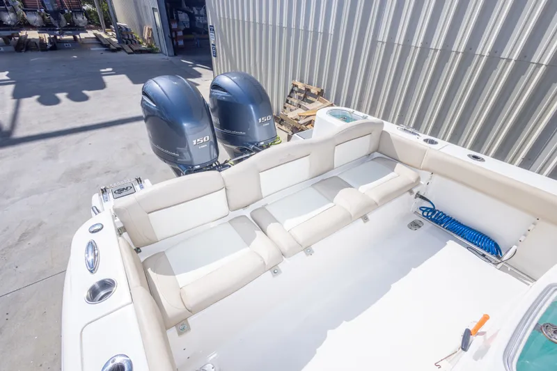 Slide: The Image of 2017 NauticStar 2602 Legacy boat with twin 150 engines, spacious seating, and storage area. - 42