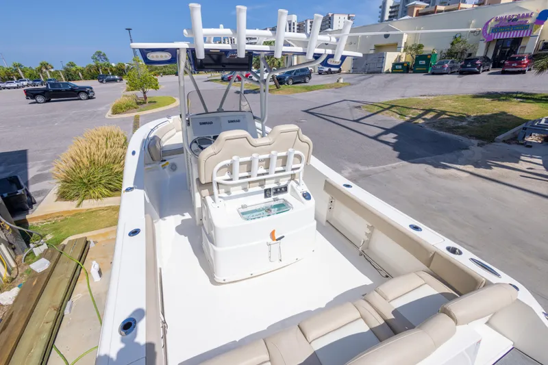 Slide: The Image of 2017 NauticStar 2602 Legacy boat interior with seating and console, parked outdoors. - 17