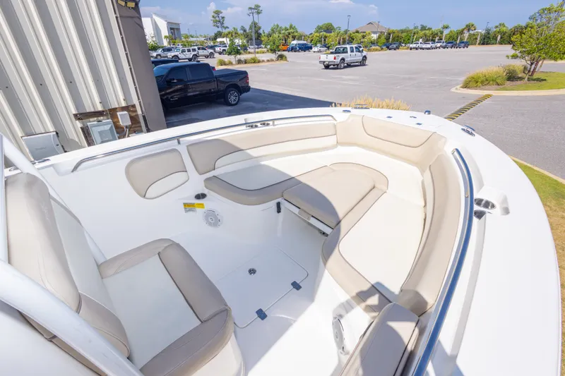 Slide: The Image of 2017 NauticStar 2602 Legacy boat with spacious seating in a parking lot setting. - 25