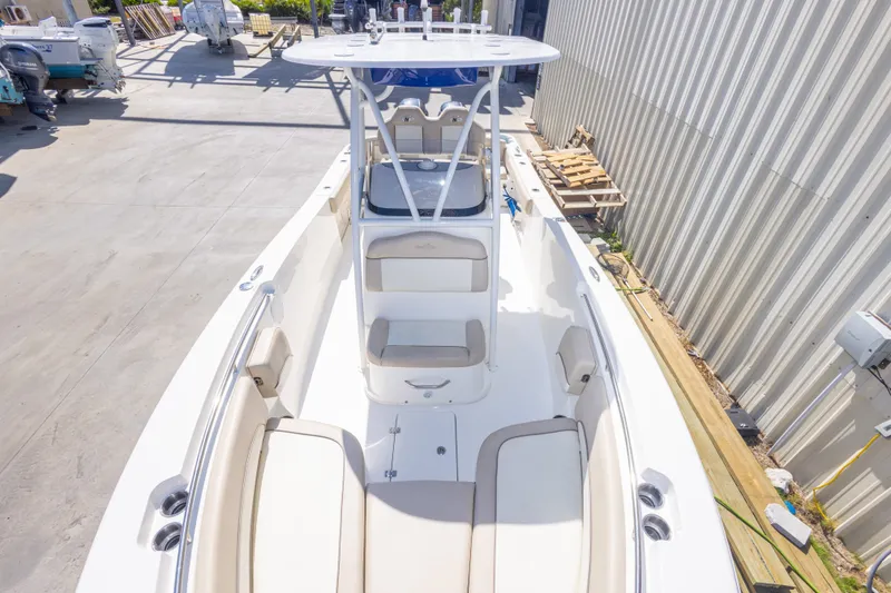 Slide: The Image of 2017 NauticStar 2602 Legacy boat with spacious seating and sleek design in a marina. - 27