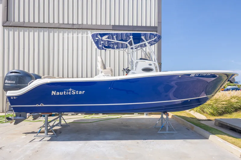 Slide: The Image of 2017 NauticStar 2602 Legacy boat with Yamaha engine, displayed outdoors. - 6