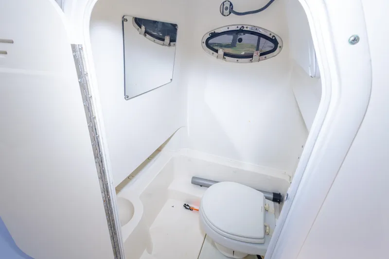 Slide: The Image of 2017 NauticStar 2602 Legacy boat interior with compact marine toilet. - 23