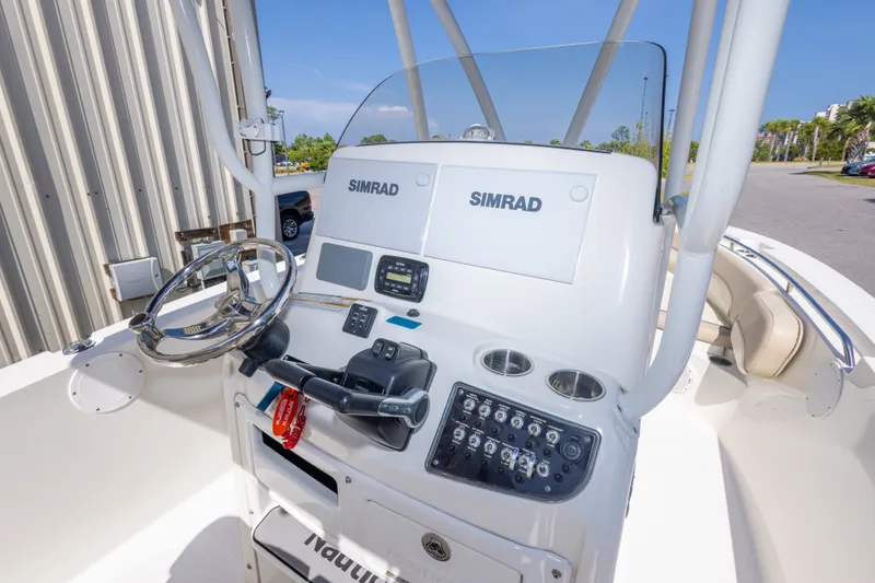 Slide: The Image of 2017 NauticStar 2602 Legacy boat console with Simrad electronics and steering wheel. - 20