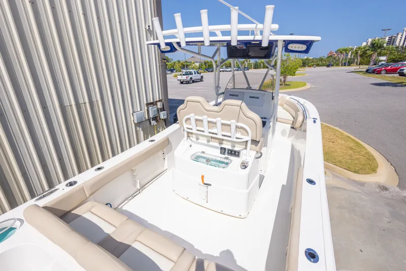 Slide: The Image of 2017 NauticStar 2602 Legacy boat with seating and console, parked outdoors. - 16