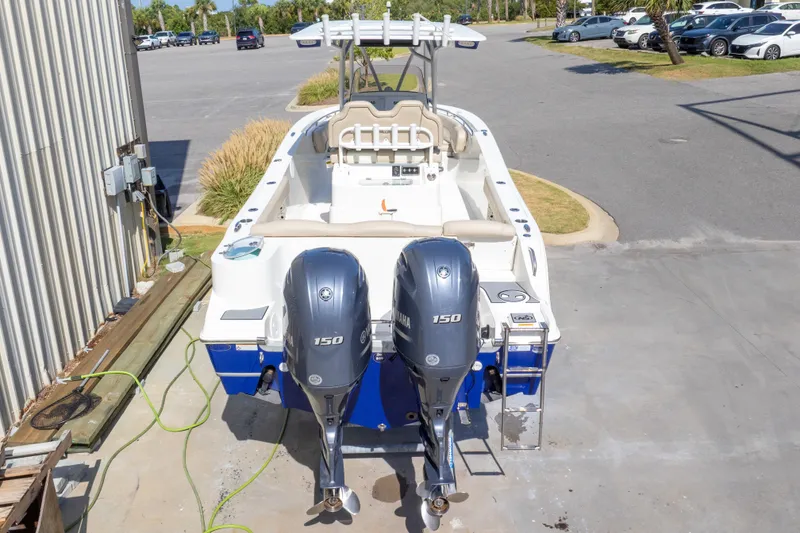 Slide: The Image of 2017 NauticStar 2602 Legacy boat with dual Yamaha 150 engines, parked outdoors. - 50