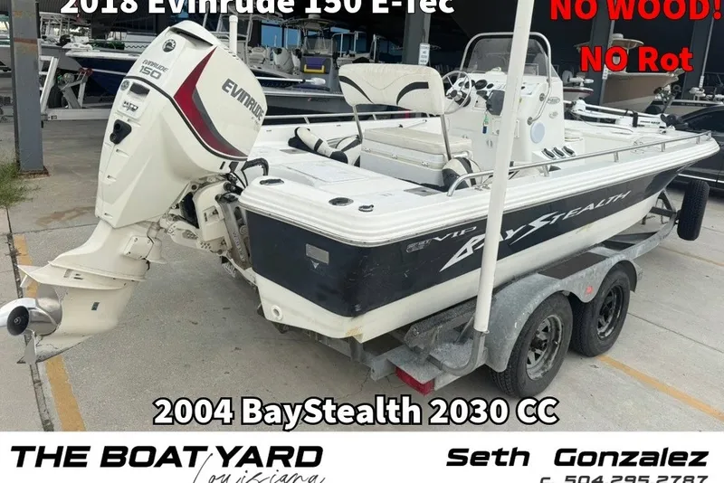 The Image of 2004 Bay Stealth 2030 boat with 2018 Evinrude 150 E-Tec engine on trailer. - 1