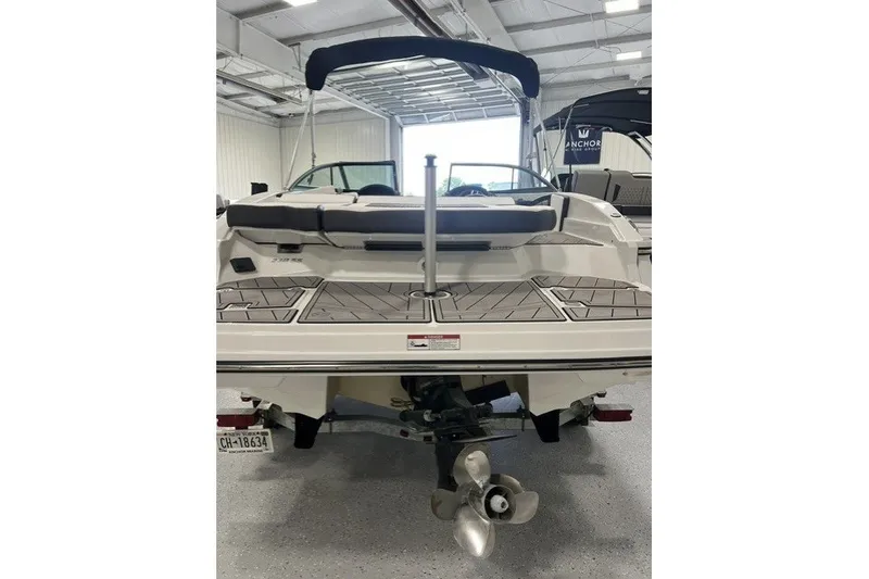 Slide: The Image of 2023 Monterey 238SS Super Sport boat in a showroom, rear view with propeller visible. - 15