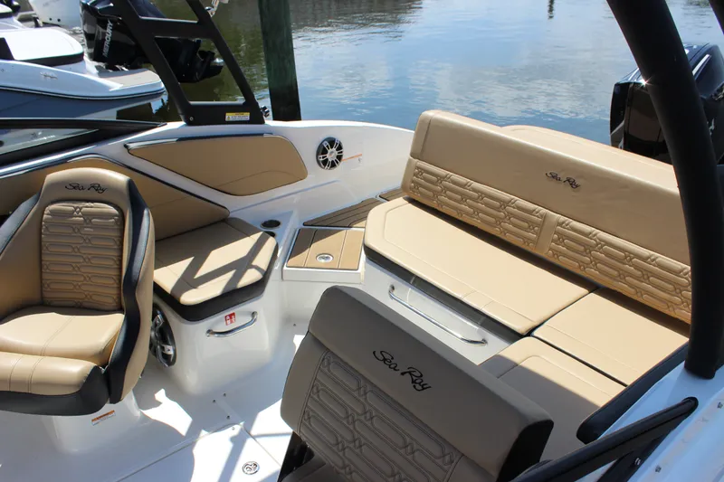 Slide: The Image of 2025 Sea Ray SPX 210 Outboard interior with tan seating and sleek design. - 4