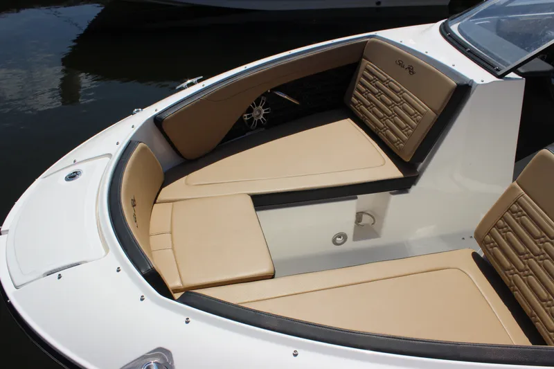 Slide: The Image of 2025 Sea Ray SPX 210 Outboard boat with tan seating and sleek design. - 2