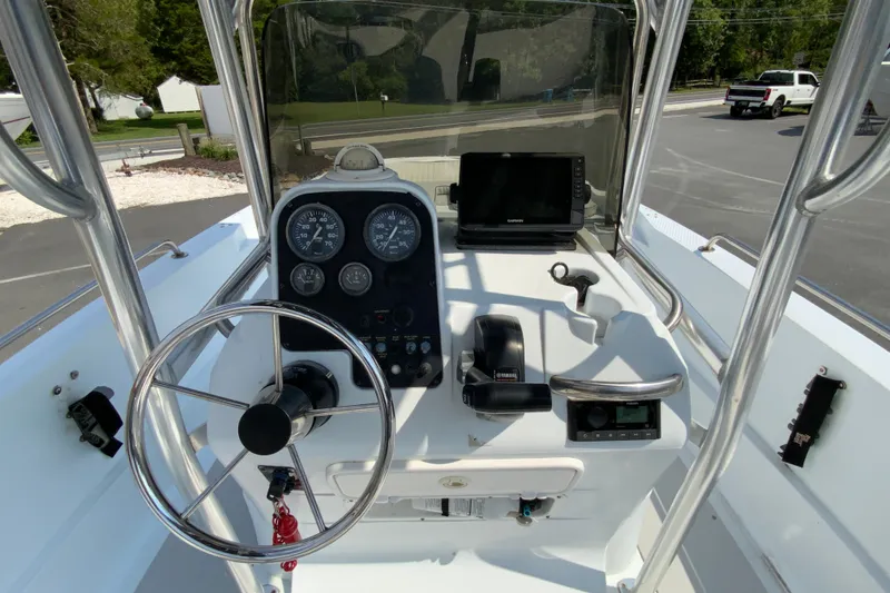 Slide: The Image of 2004 Triumph 190 Bay boat console with steering wheel and navigation equipment. - 10