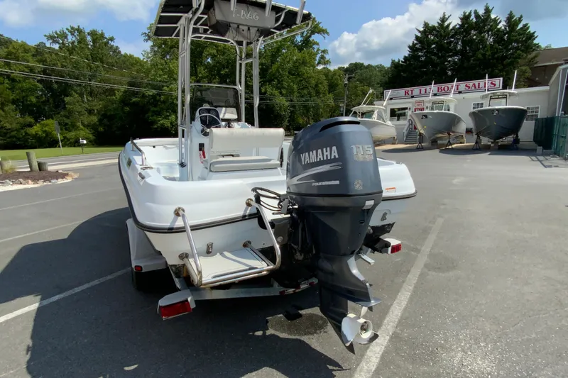 Slide: The Image of 2004 Triumph 190 Bay boat with Yamaha 115 outboard motor at dealership. - 7
