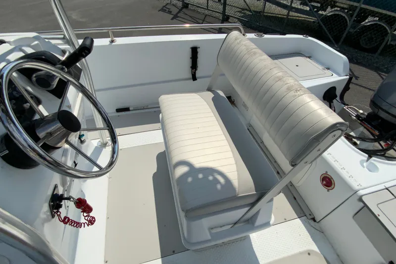 Slide: The Image of Interior of 2004 Triumph 190 Bay boat with steering wheel and seating. - 12