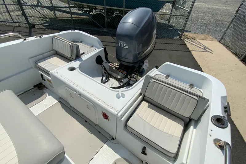 Slide: The Image of 2004 Triumph 190 Bay boat interior with Yamaha 115 outboard motor, featuring cushioned seating. - 14