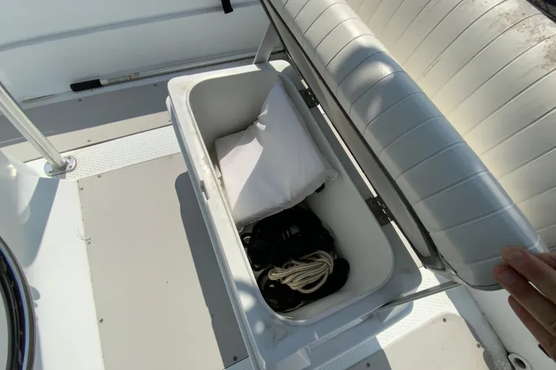 Slide: The Image of Open storage compartment on 2004 Triumph 190 Bay boat with rope and pillow inside. - 13