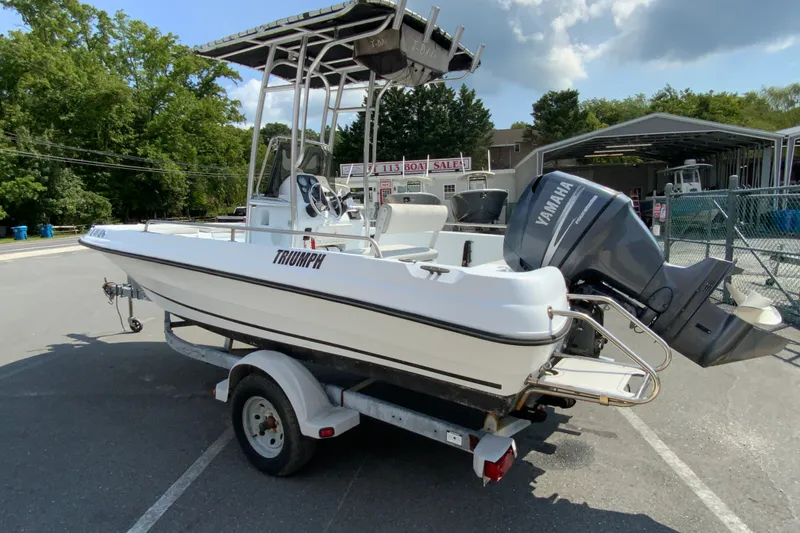Slide: The Image of 2004 Triumph 190 Bay boat with Yamaha outboard motor on trailer. - 6