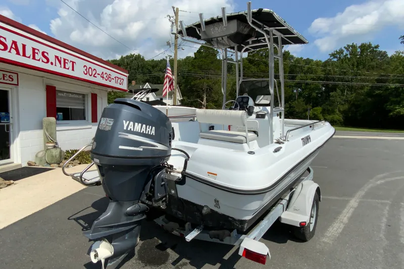 Slide: The Image of 2004 Triumph 190 Bay boat with Yamaha outboard motor on trailer, parked outside sales office. - 8