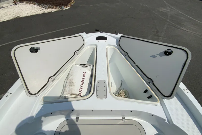 Slide: The Image of 2004 Triumph 190 Bay boat storage compartments with safety gear bag and rope. - 19