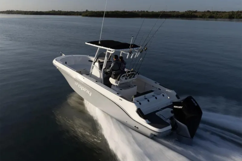 Slide: The Image of Manufacturer Provided Image: 2025 Bayliner Trophy T24CC boat cruising on calm water, rear view. - 1