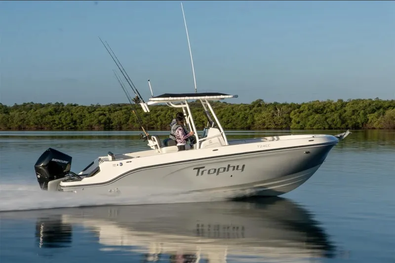 The Image of Manufacturer Provided Image: 2025 Bayliner Trophy T24CC boat cruising on calm water with lush greenery in the background. - 0