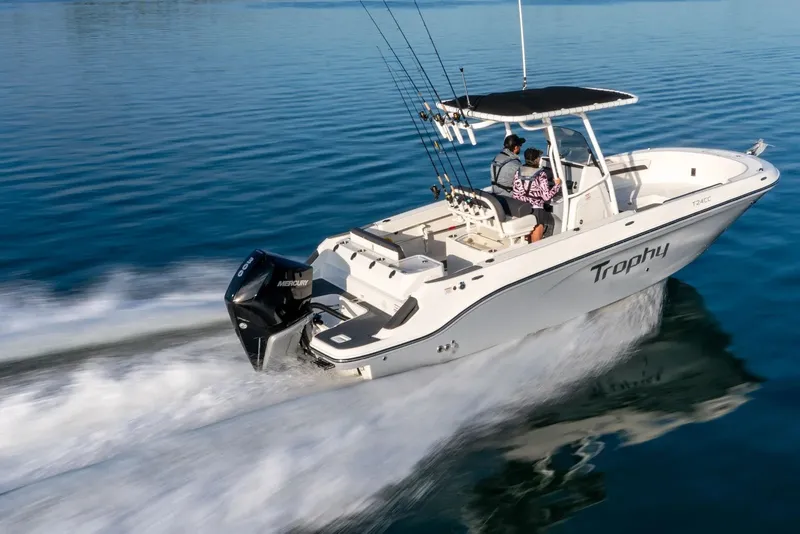 Slide: The Image of 2026 Bayliner Trophy T24CC boat cruising on clear blue water. - 7