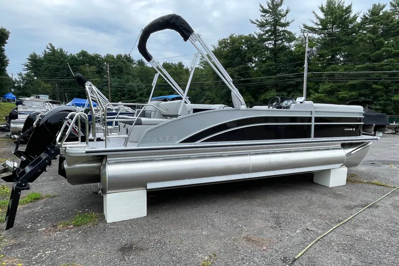 The Image of 2027 Harris Cruiser 230 SL pontoon boat on display in outdoor setting. - 0