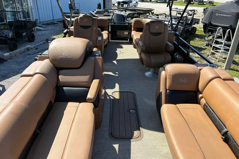 Slide: The Image of 2024 Regency 230 LE3 pontoon boat with luxurious tan seating and spacious layout. - 4