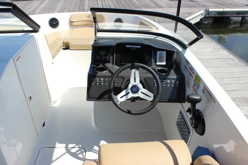 Slide: The Image of 2026 Bayliner VR6 Bowrider OB cockpit with steering wheel and dashboard controls. - 9