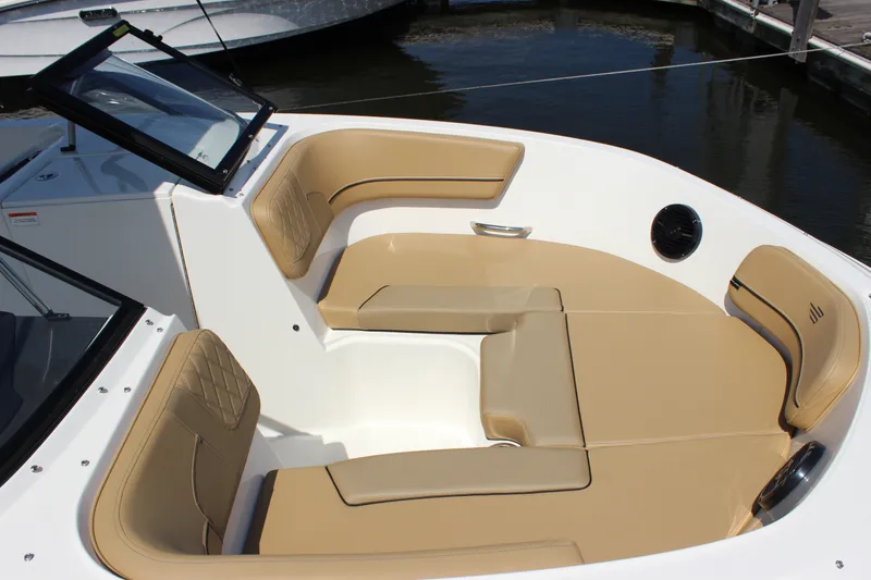 Slide: The Image of 2026 Bayliner VR6 Bowrider OB interior with tan seating and modern design. - 11