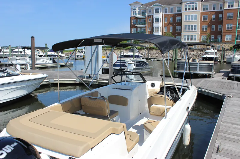 Slide: The Image of 2026 Bayliner VR6 Bowrider OB docked at marina, featuring sleek design and spacious seating. - 6