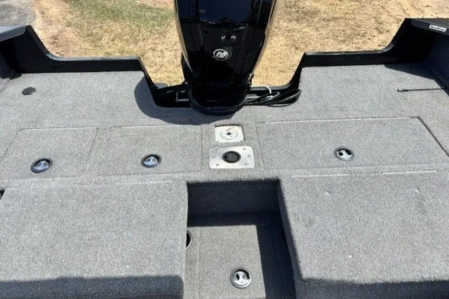 Slide: The Image of 2023 Tracker Pro Guide V-175 Combo boat interior with carpeted deck and motor. - 15