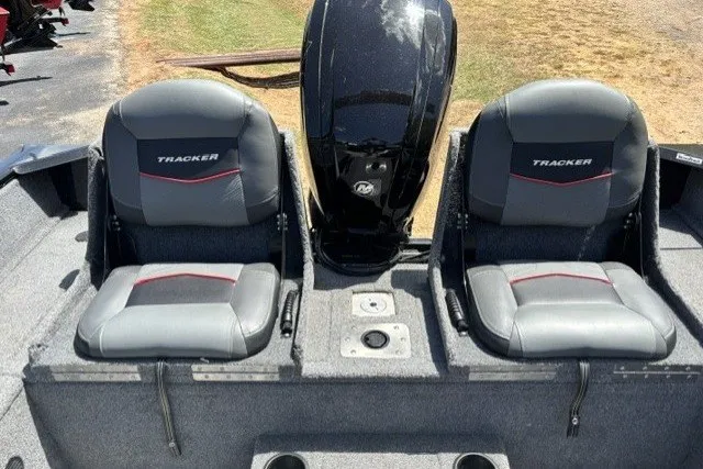 Slide: The Image of 2023 Tracker Pro Guide V-175 Combo boat seats and motor, outdoor setting. - 16