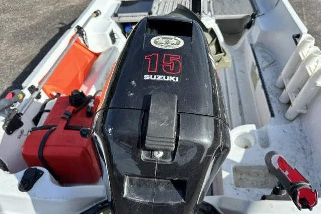 Slide: The Image of 2003 Pelican Predator boat with Suzuki 15 outboard motor, red fuel tank visible. - 13