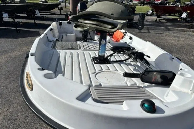 Slide: The Image of 2003 Pelican Predator boat with seating and equipment on display outdoors. - 6