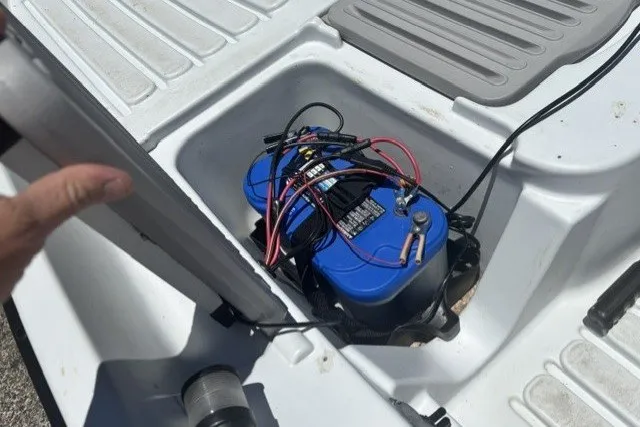 Slide: The Image of Battery compartment in a 2003 Pelican Predator boat with visible wiring. - 20