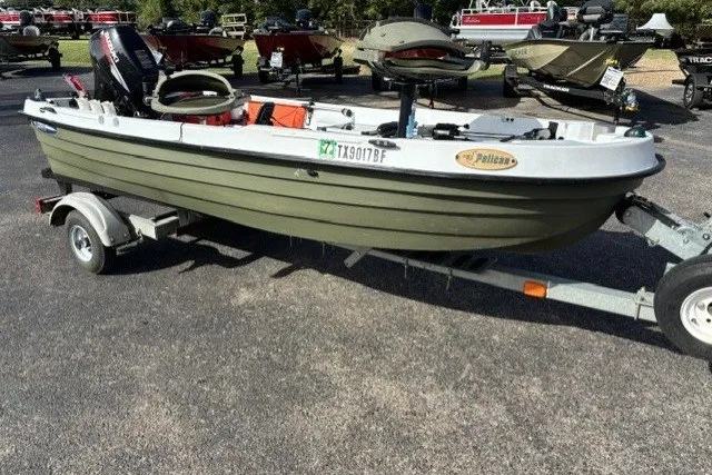 Slide: The Image of 2003 Pelican Predator boat on trailer in outdoor setting. - 5