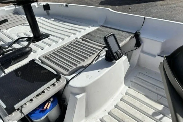 Slide: The Image of Interior of a 2003 Pelican Predator boat with electronic equipment and storage compartments. - 12