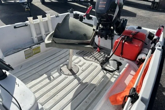 Slide: The Image of 2003 Pelican Predator boat interior with motor, seat, and storage compartments. - 11