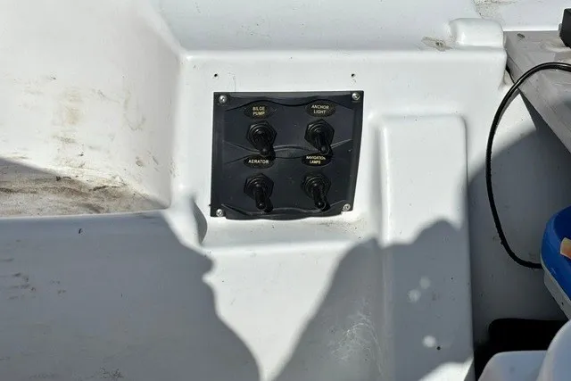 Slide: The Image of Control panel on a 2003 Pelican Predator boat with four switches. - 14