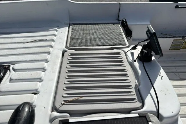 Slide: The Image of 2003 Pelican Predator boat deck with mounted equipment and textured surfaces. - 10