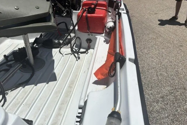 Slide: The Image of Interior of a 2003 Pelican Predator boat with equipment and red fuel tank. - 21