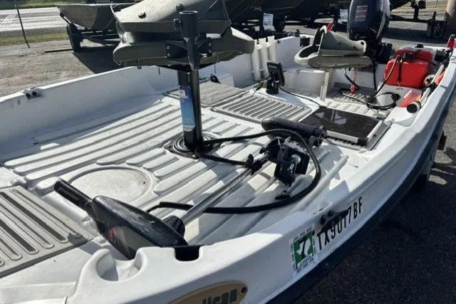 Slide: The Image of 2003 Pelican Predator boat interior with seating and equipment, docked outdoors. - 7