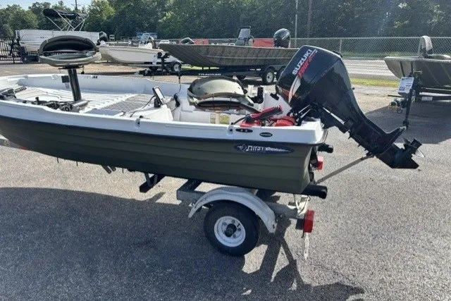 Slide: The Image of Small Pelican Predator 2003 boat with Suzuki outboard motor on trailer. - 3