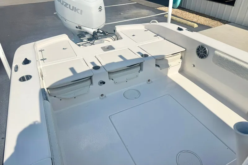 Slide: The Image of 2027 Carolina Skiff 26 Ultra Elite boat interior with Suzuki engine, featuring storage compartments. - 30