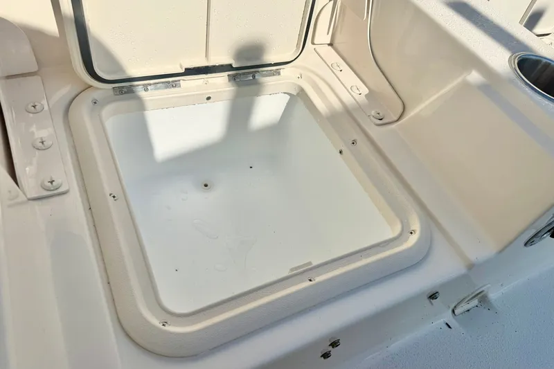 Slide: The Image of 2027 Carolina Skiff 26 Ultra Elite boat storage compartment, open and empty. - 36