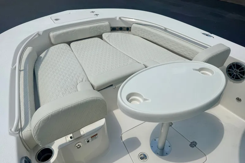 Slide: The Image of Luxurious seating area on 2027 Carolina Skiff 26 Ultra Elite boat with table and cup holders. - 11