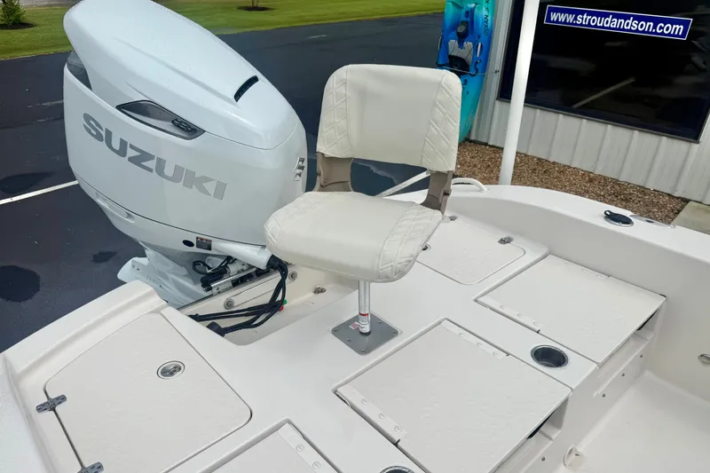 Slide: The Image of 2027 Carolina Skiff 26 Ultra Elite boat with Suzuki outboard motor and cushioned seat. - 31