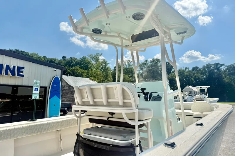 Slide: The Image of 2027 Carolina Skiff 26 Ultra Elite boat with T-top, parked outdoors under blue sky. - 44