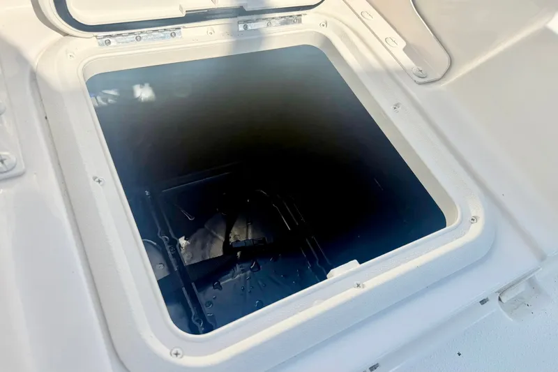 Slide: The Image of Open storage compartment on a 2027 Carolina Skiff 26 Ultra Elite boat. - 35